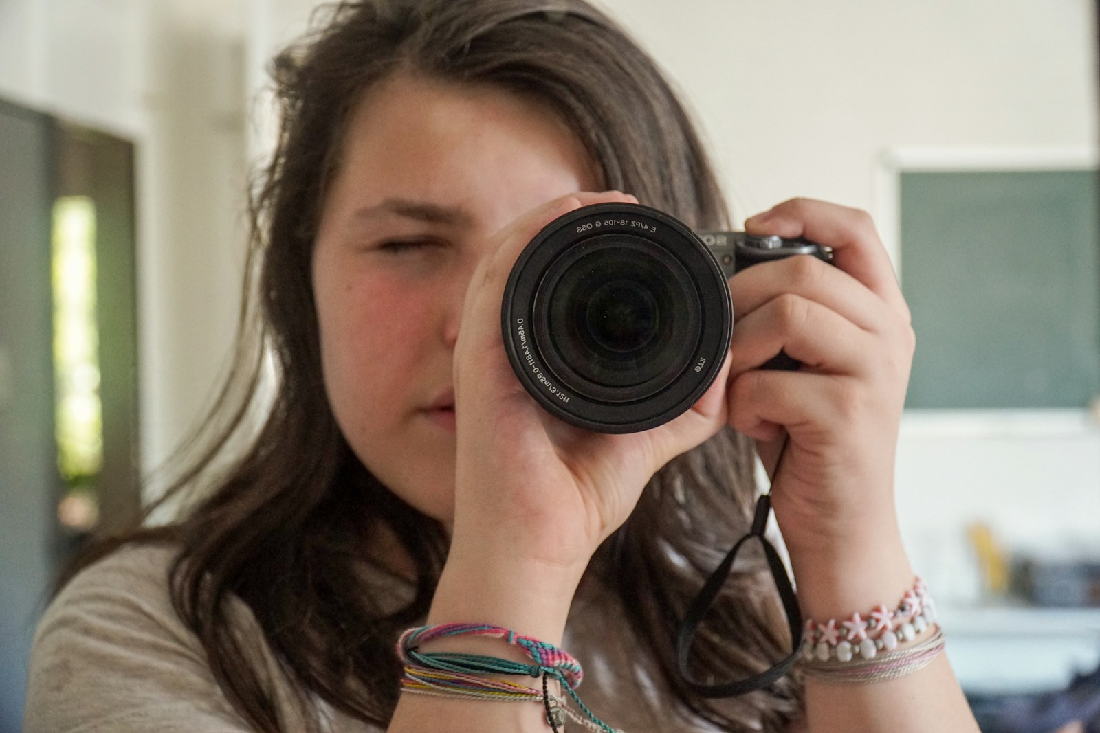 woman holding black camera taking photo