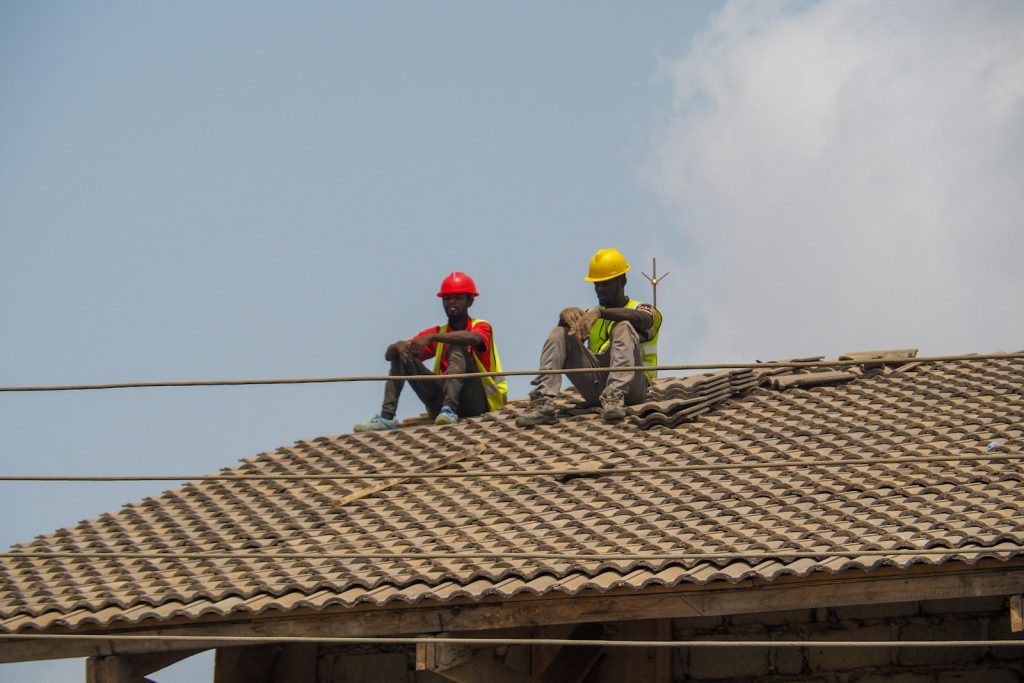 Two construction workers are taking a break.